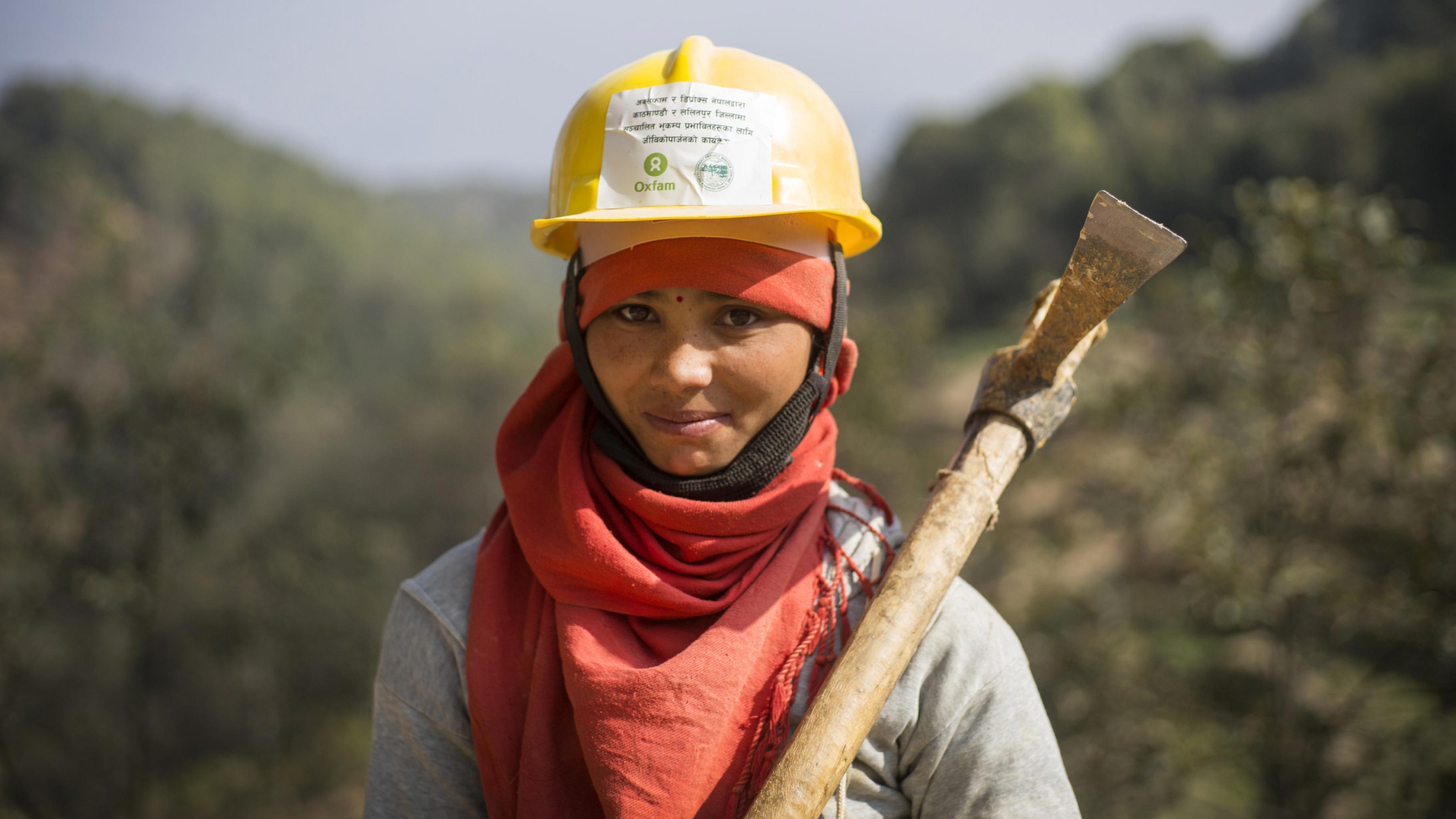 Eine Frau in Nepal mit einer Spitzhacke