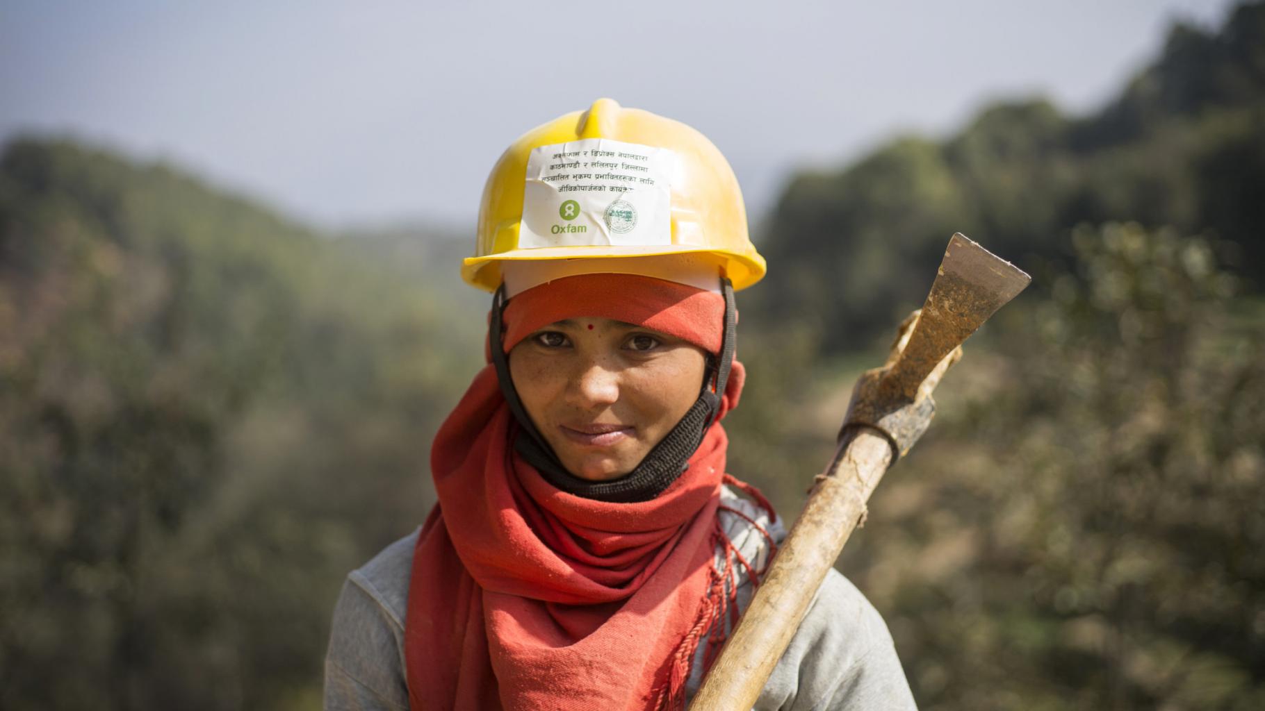 Eine Frau in Nepal mit einer Spitzhacke